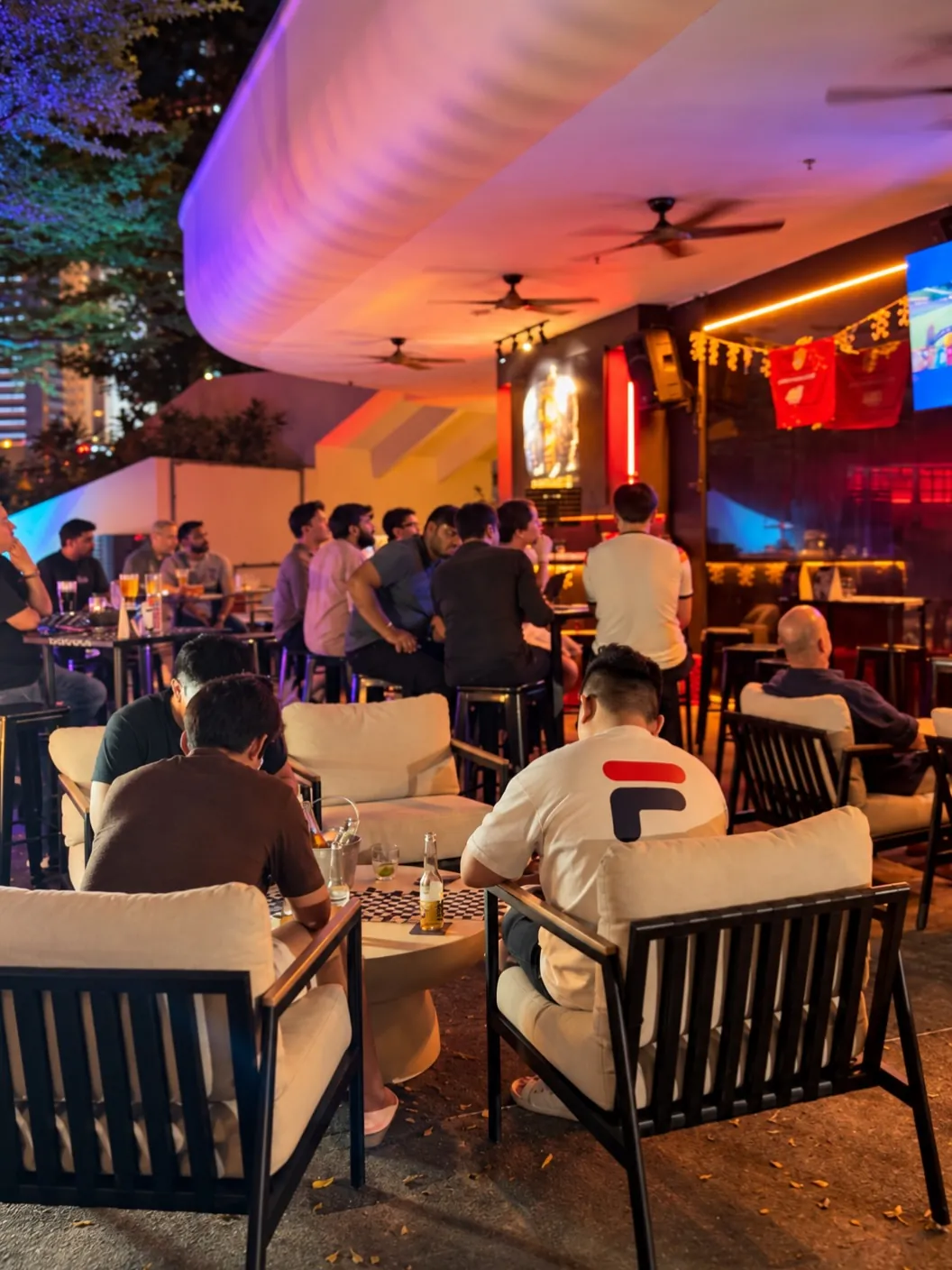 Guests at the open-air seating under the canopy at Alfresco by Destino in the evening